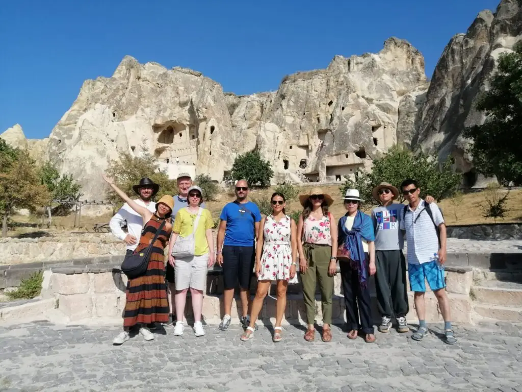 Tour group exploring Cappadocia’s fairy chimneys with their guide during the 7 Days Turkey Tour