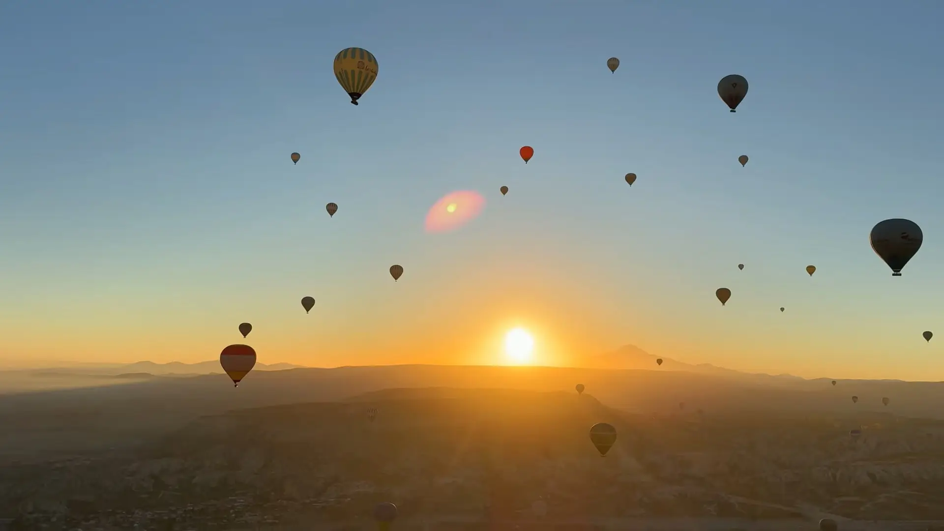 Hot air balloons over Cappadocia at sunrise, Turkey – best viewpoints to witness the region’s fairy chimneys and valleys