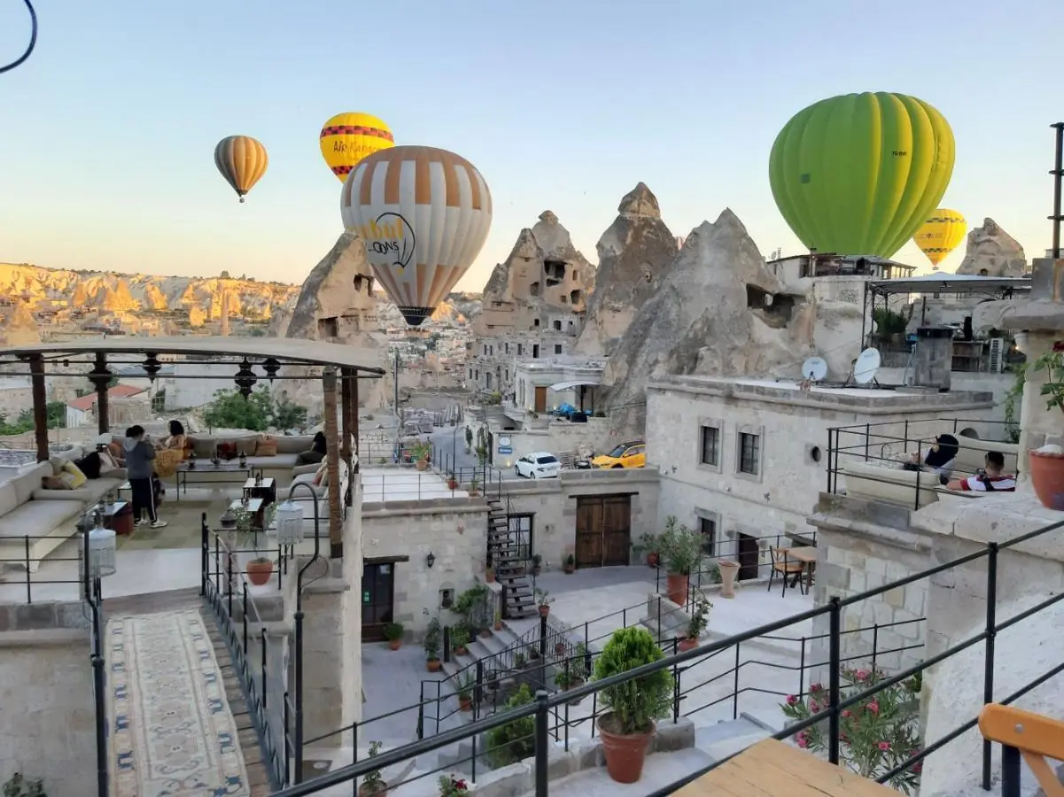 Exterior view of Artemis Cave Suites Hotel in Göreme, Cappadocia, featuring traditional cave-style rooms and a scenic landscape.