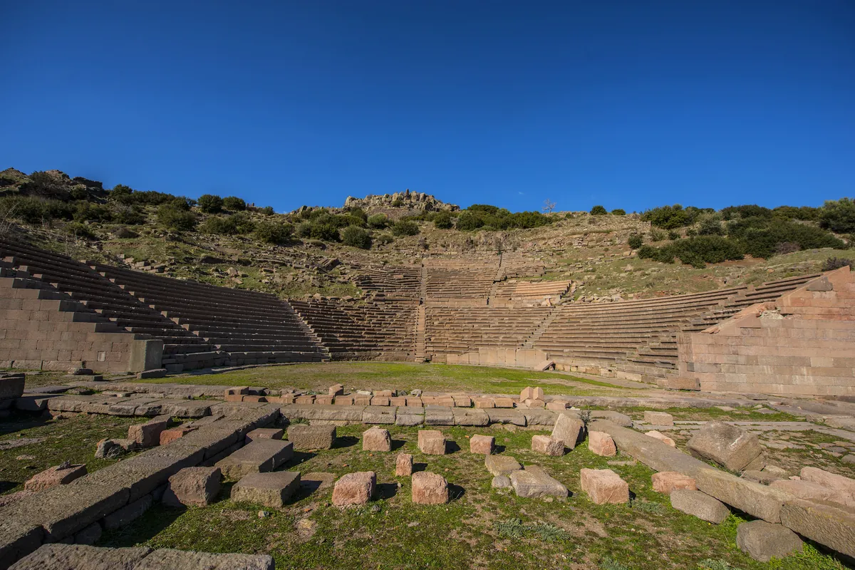 Stone seats and stage area of the Ancient Theater in Troy, showcasing the cultural life of the legendary city in Turkey.
